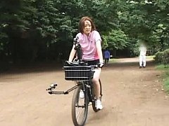 Anri Hiramatsu Asian walks in the park with bike r...